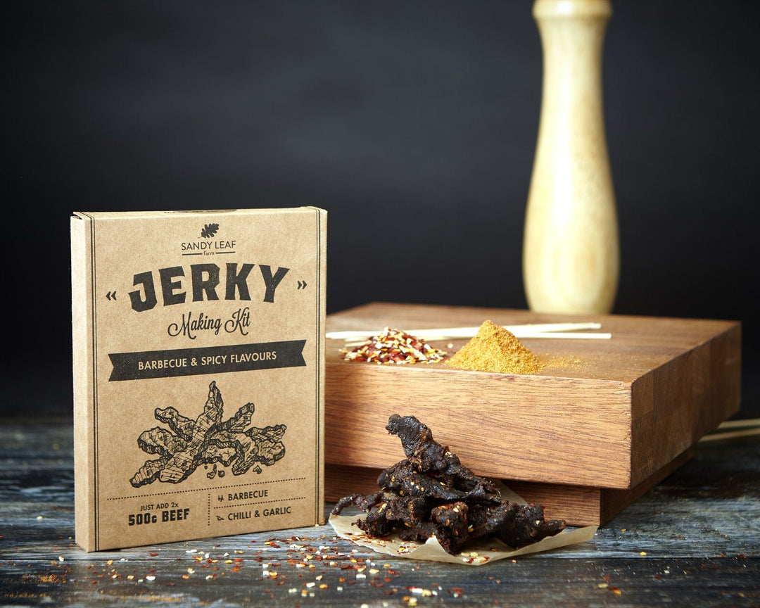 Beef jerky making kit with seasoning blends and strips of homemade beef jerky